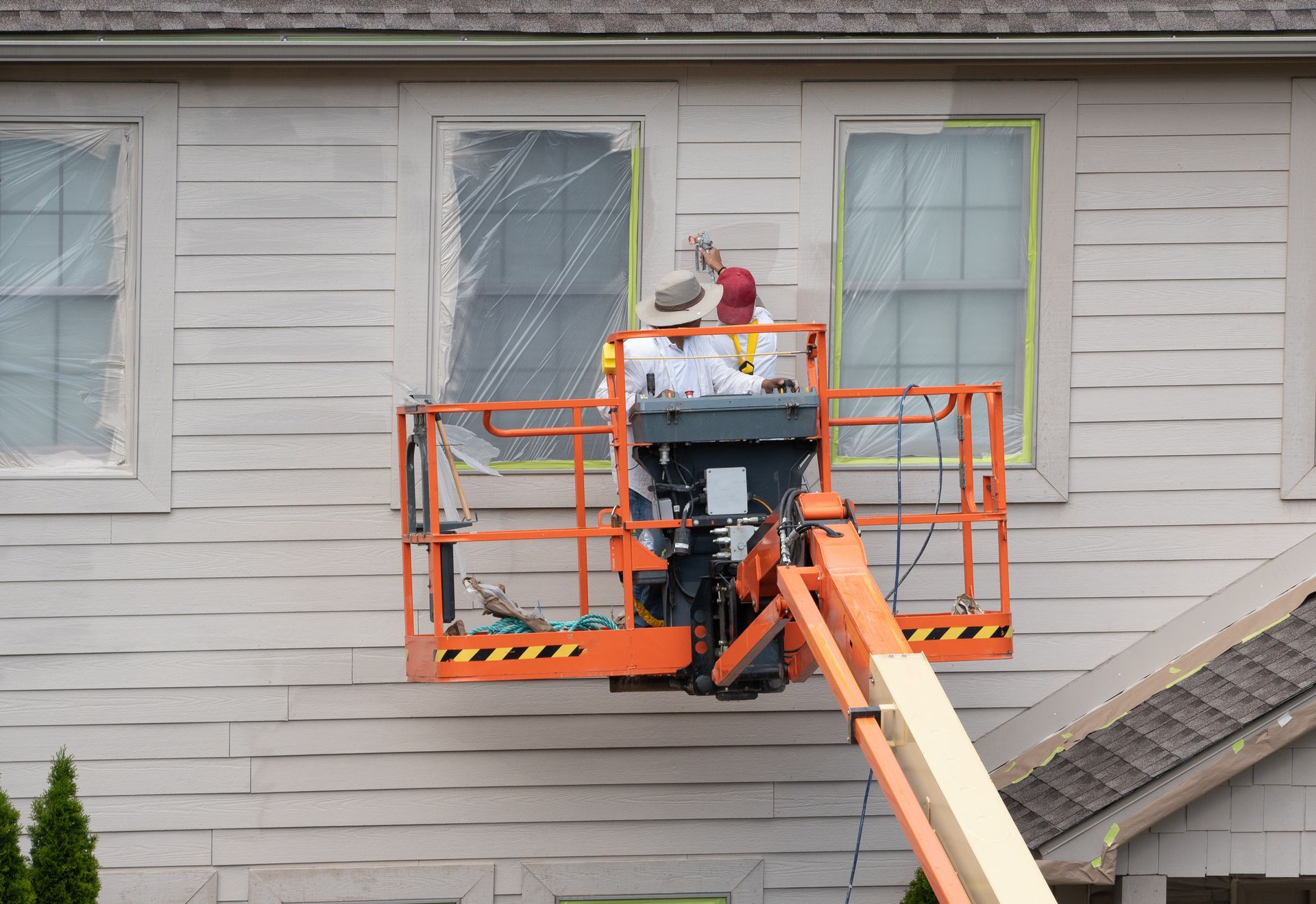 Professional painters painting the exterior of a home in Connecticut with updated siding and front d