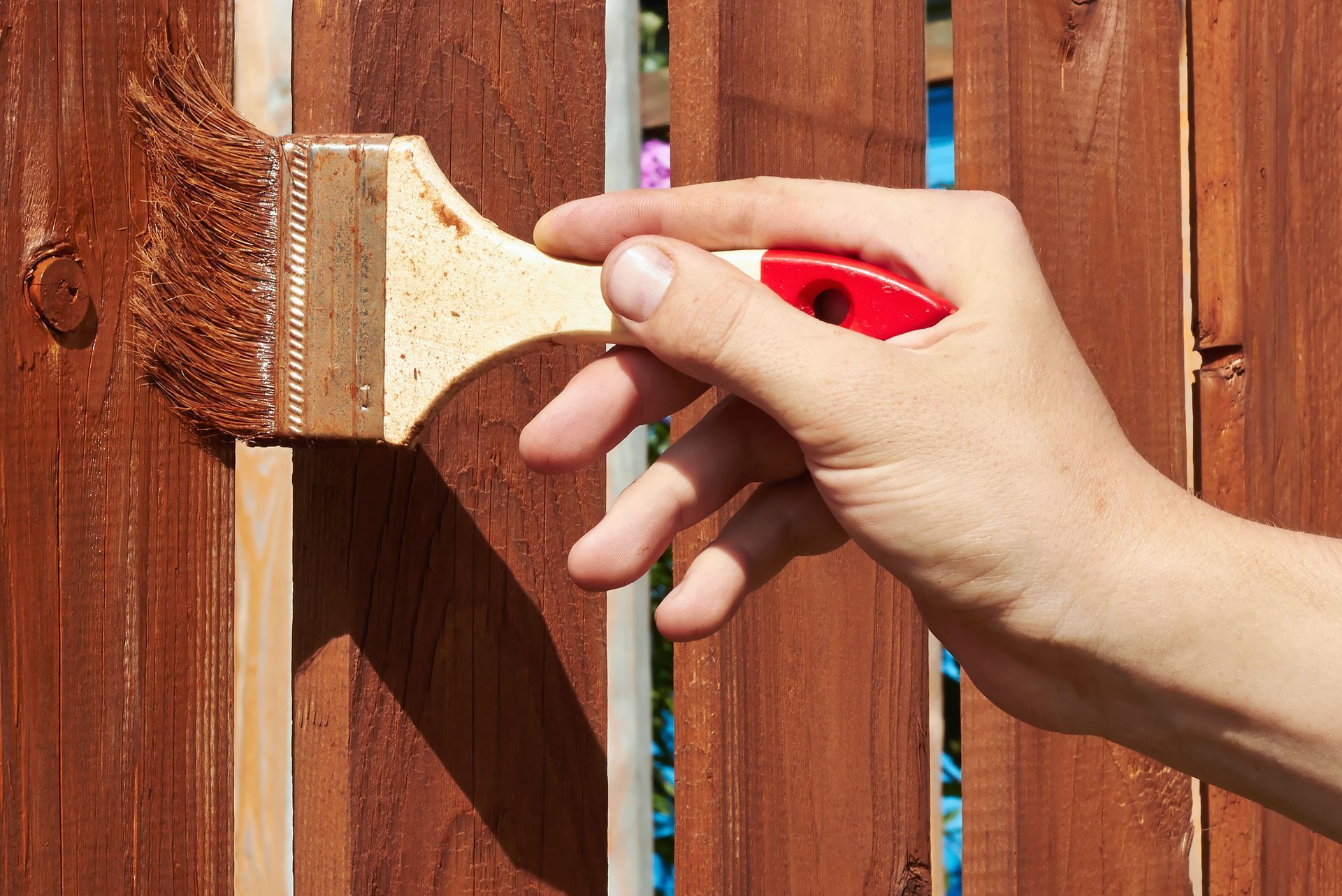Fence painting project in Western MA, creating a clean, uniform finish that complements the deck and home exterior.