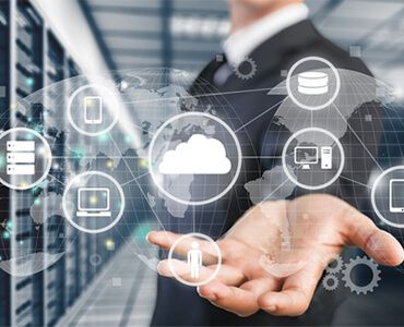 A man in a suit is holding a virtual screen with icons on it.