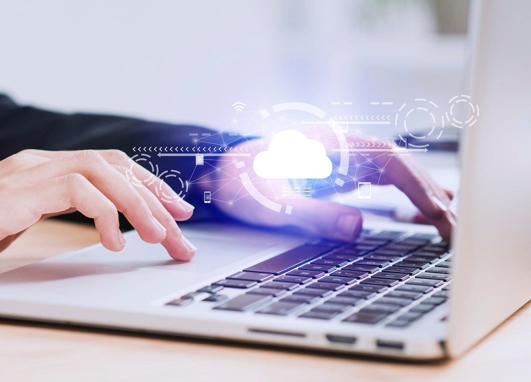 A person is typing on a laptop computer.