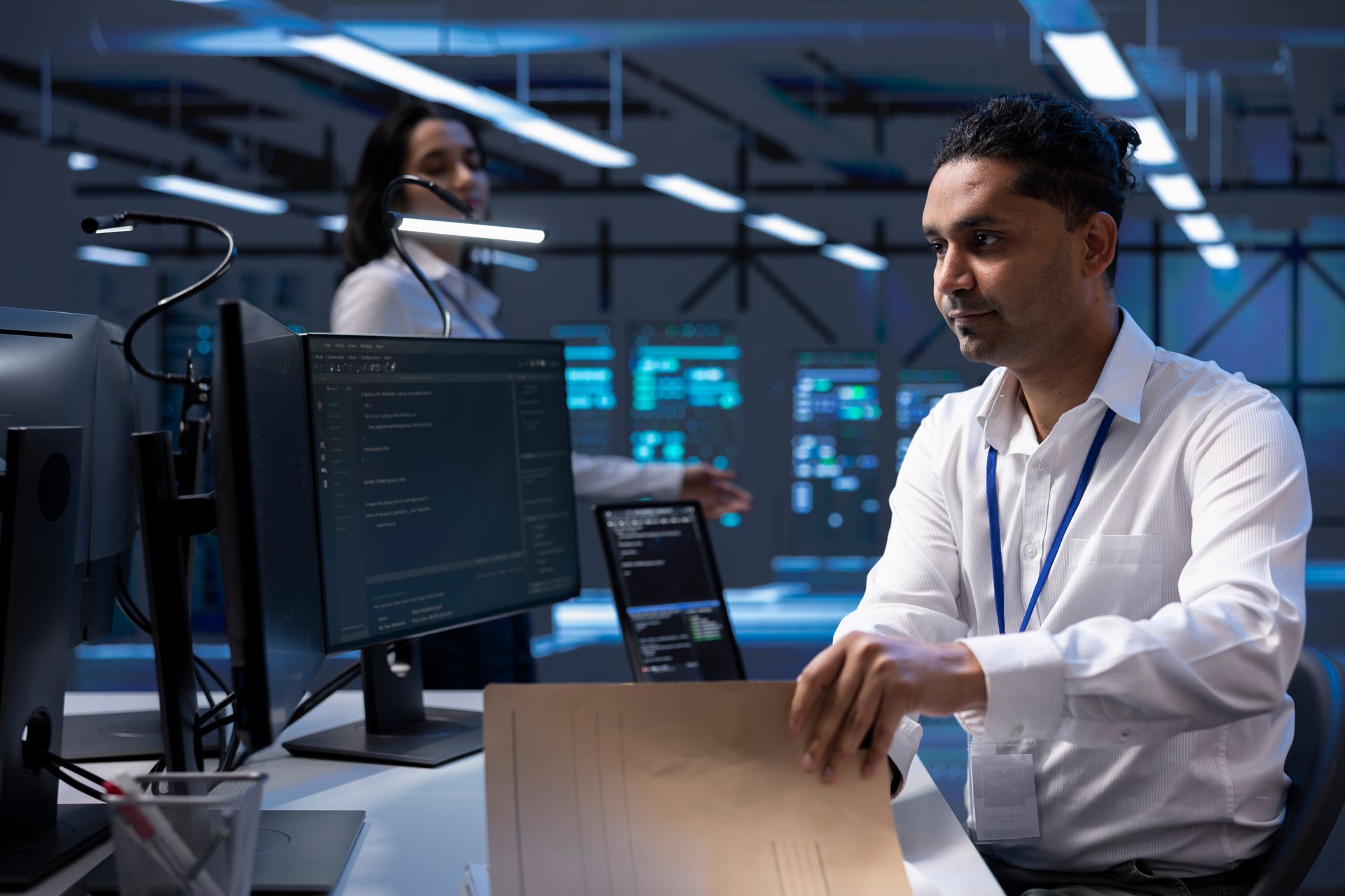 A man is sitting at a desk in front of a computer.