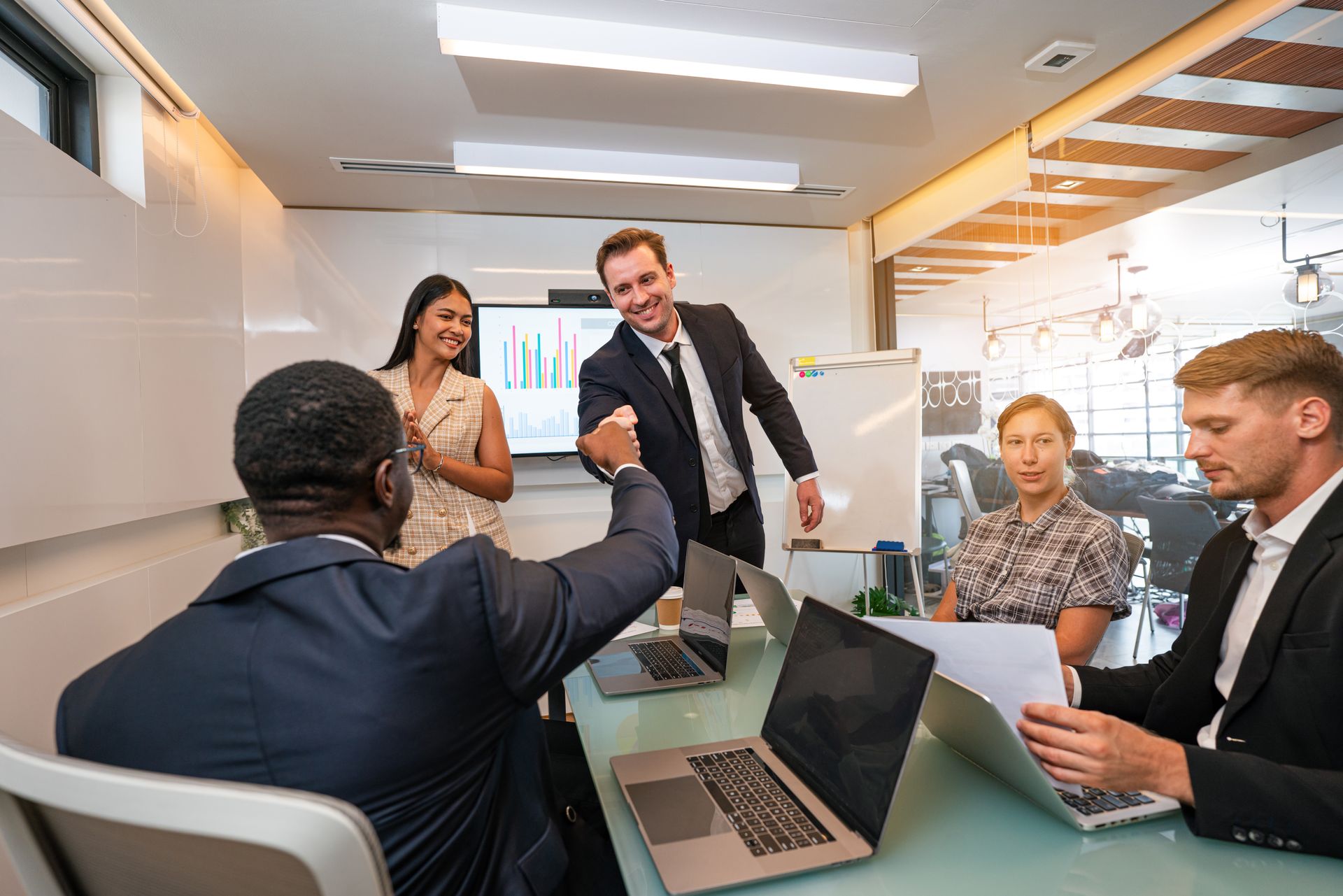 A group of business people are having a meeting in a conference room.