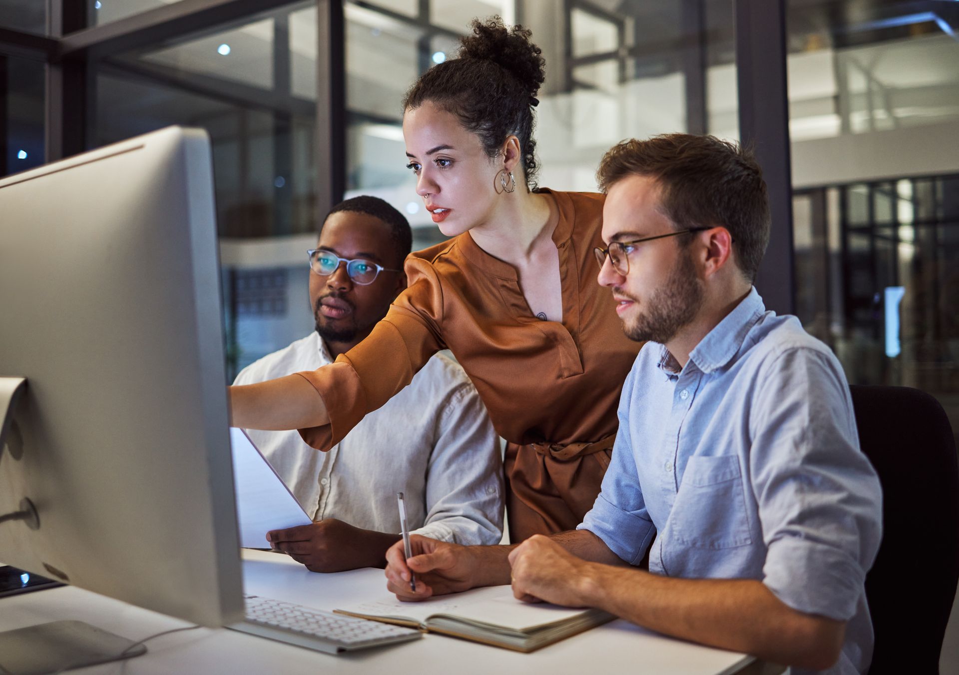 A group of people are looking at a computer screen.