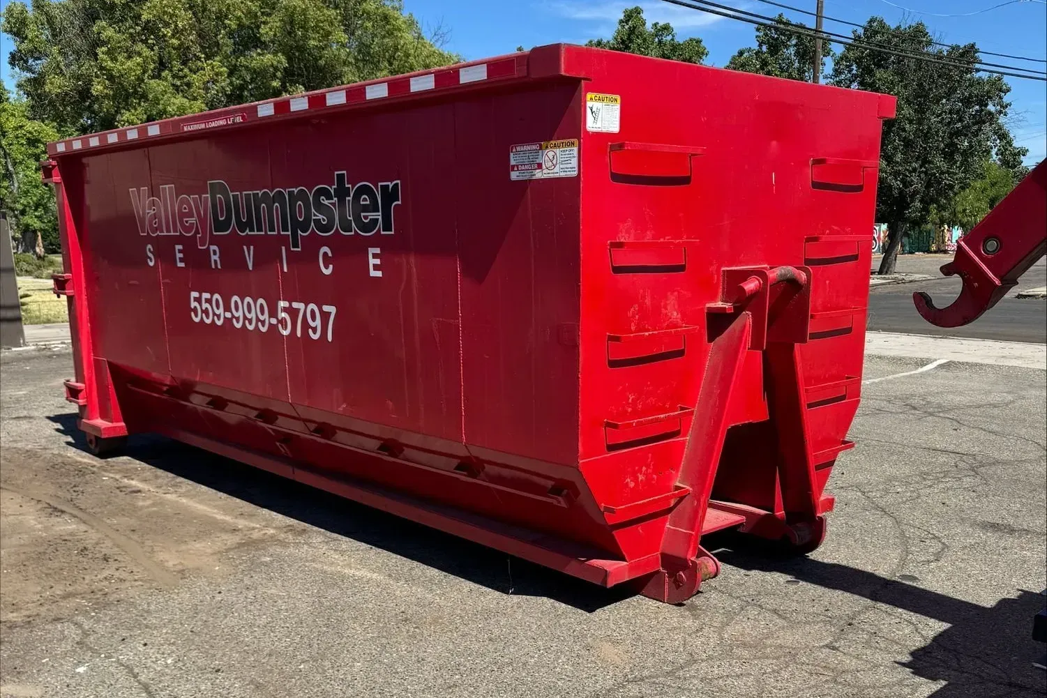 Roofing tear-off debris loaded into a Valley Dumpster Service container