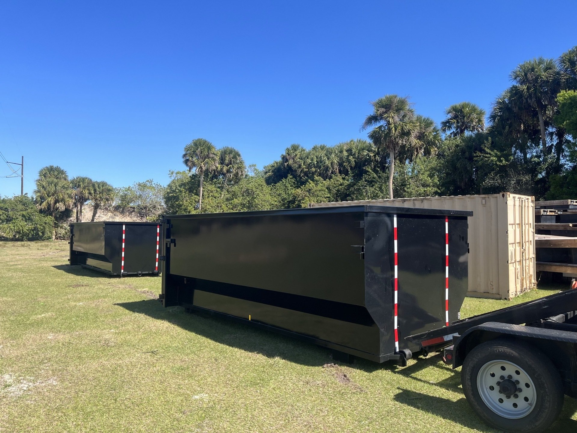 dumpsters on patch of grass