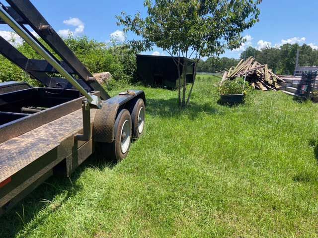 Dumpster rental dropped off by trailer