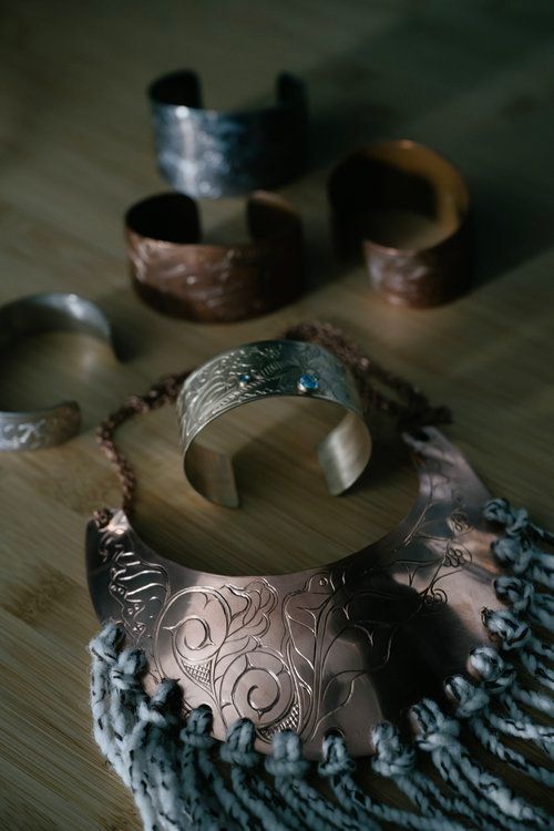 A group of bracelets are sitting on top of a wooden table.