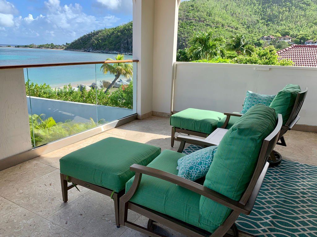Turquoise patio lounge chairs and ottoman overlooking Mahoe Bay