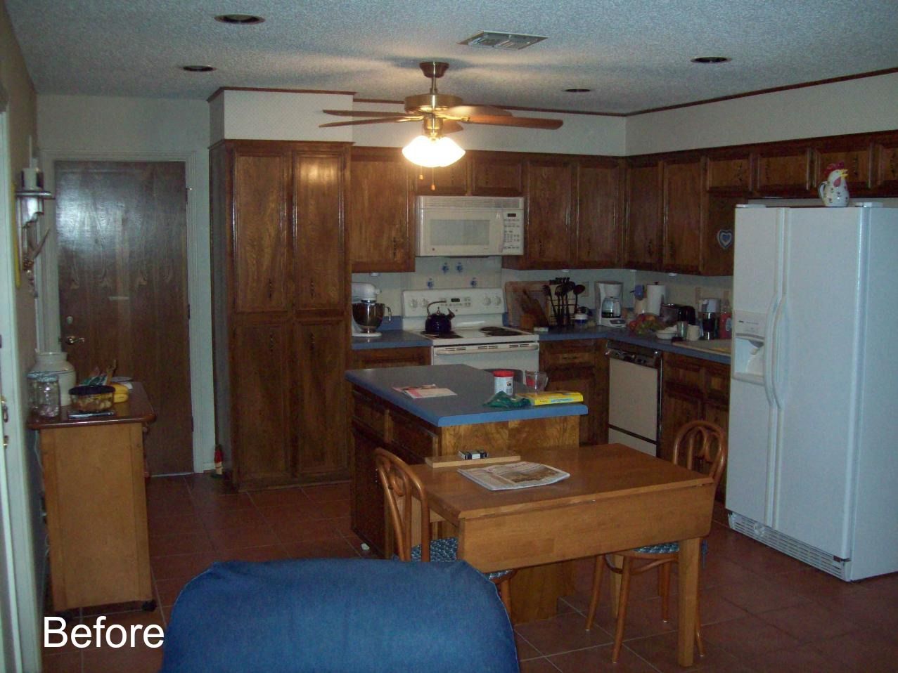 A before photo of a kitchen with a table and chairs