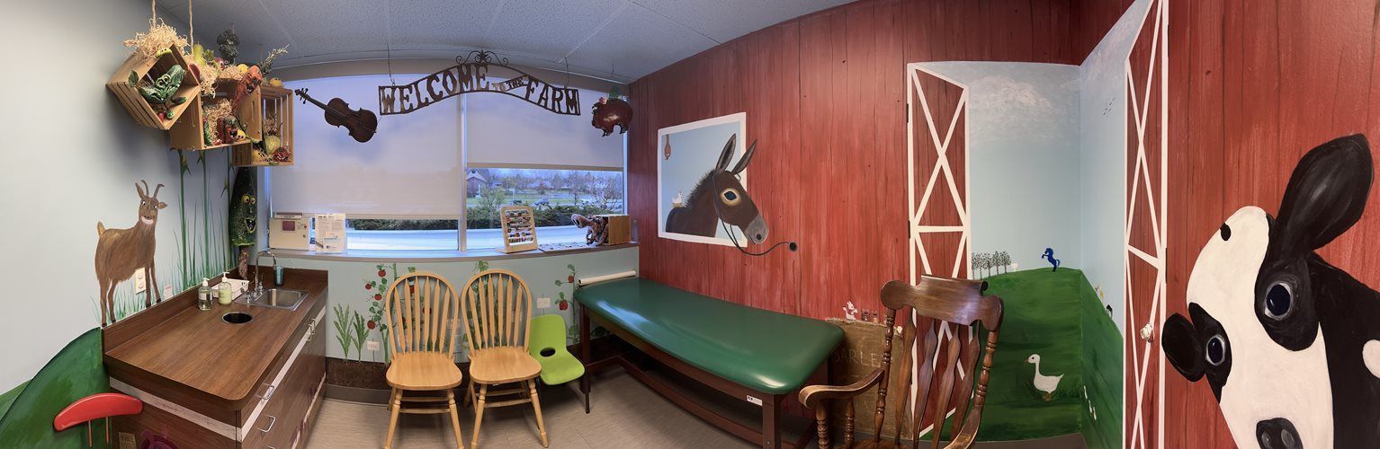 Cozy room with wooden table, chairs, green bench, potted plants, and a large cow mural on the right wall