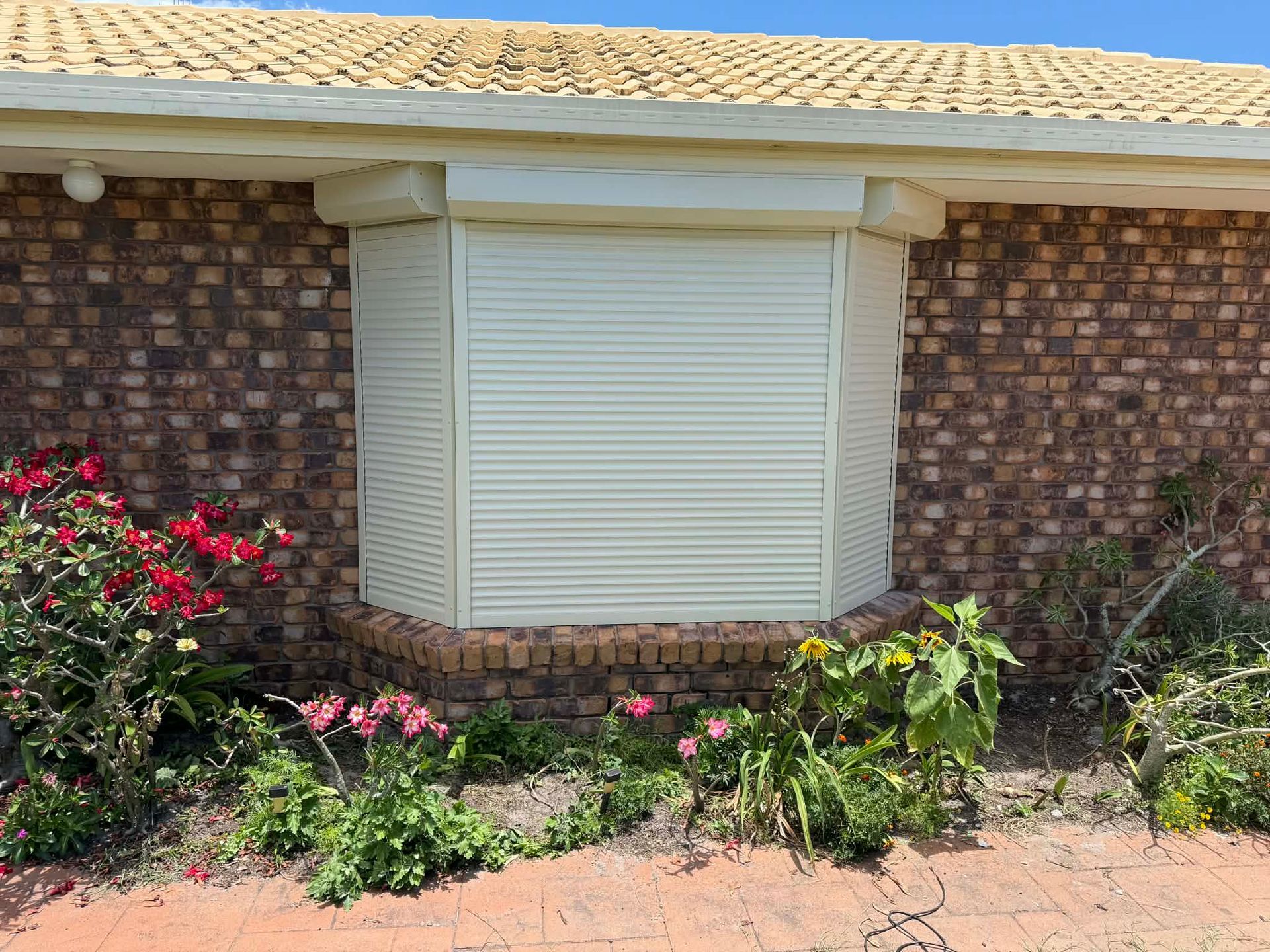 Brick House Exterior with White Window Shutter — Advantage Screens and Blinds Hervey Bay In Pialba, Queensland
