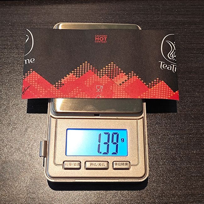 Weighing a half paper sample on a digital scale for GSM measurement