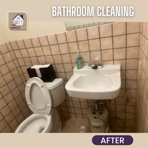 A clean bathroom with a white sink, toilet, and beige tile, labeled