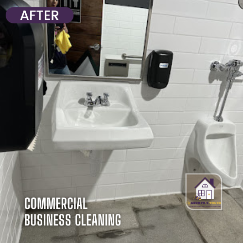 Cleaned commercial bathroom with a sink, mirror, soap dispenser, and urinal.