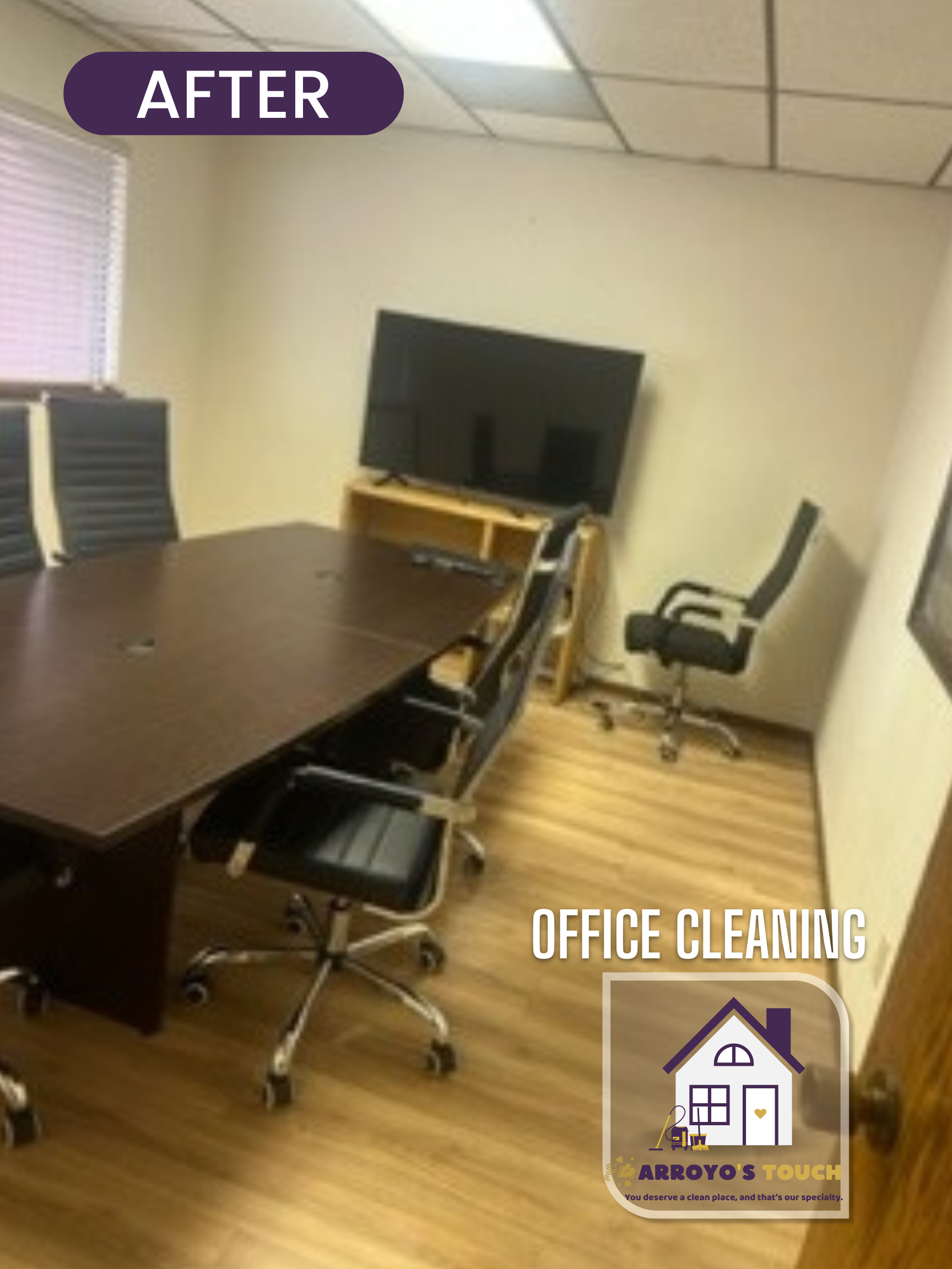Cleaned office with a large conference table, chairs, TV, and light wood flooring.