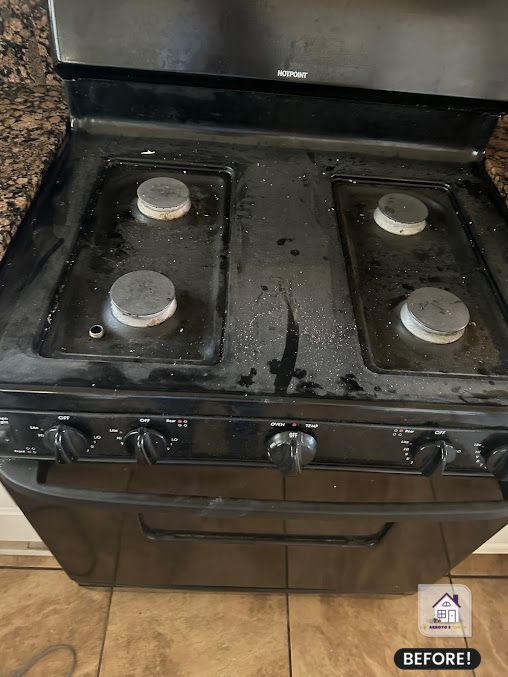 Dirty black stovetop with four burners, before cleaning.