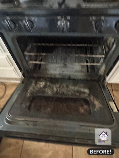 Dirty oven interior with visible food residue and grease.