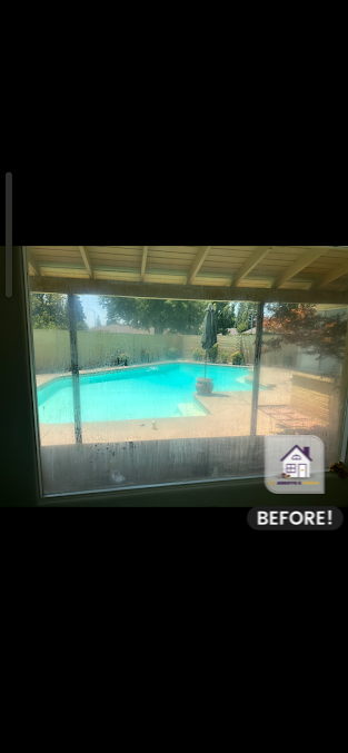 View of a pool through a screened-in porch, labeled