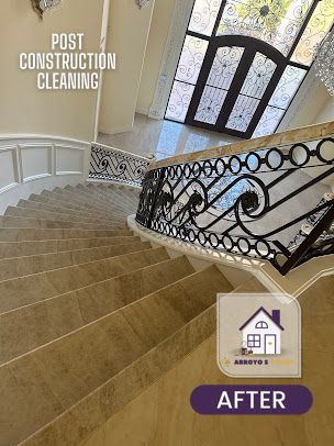 Cleaned marble staircase with wrought iron railing, after post-construction cleaning.