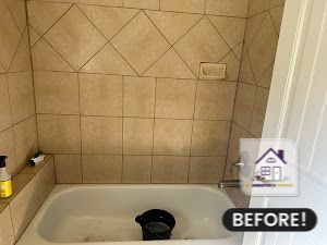 Bathroom with beige tile, bathtub, and soap dish, before renovation.