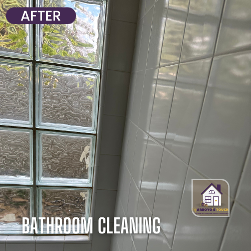 Clean white bathroom tile and glass block window after cleaning.