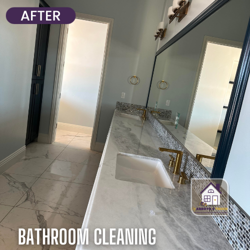 Cleaned bathroom with marble countertop, gold fixtures, and tiled floor, labeled