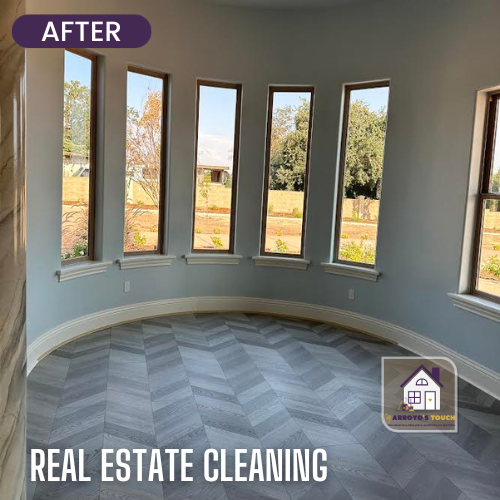 Clean interior room with curved wall, tall windows, and chevron flooring; real estate cleaning.