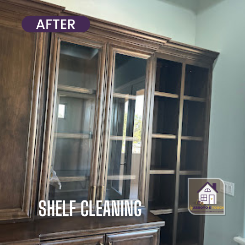 Dark wood display cabinet with clean glass doors after shelf cleaning.