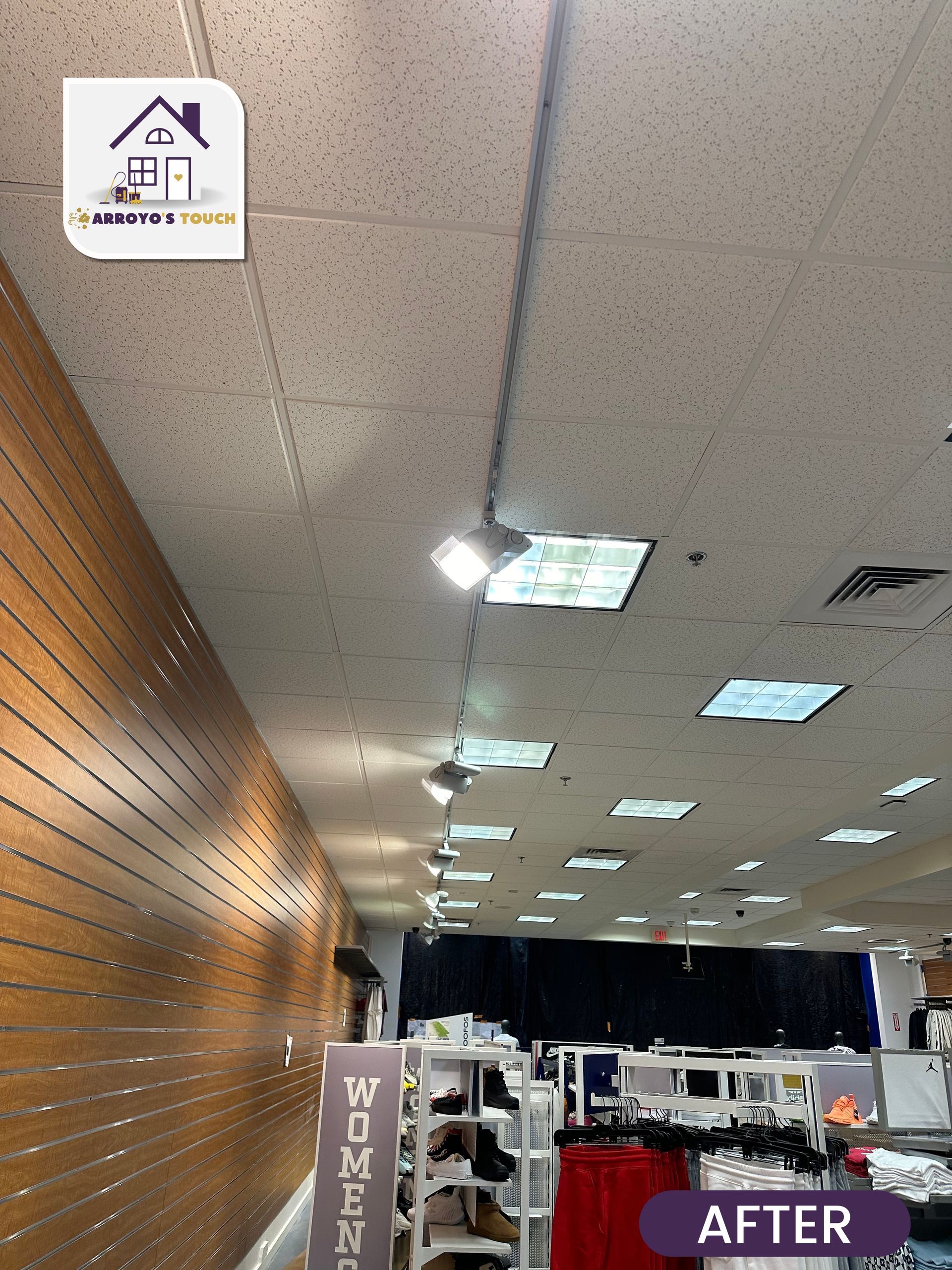 Retail store interior with brown wooden wall and track lighting, 