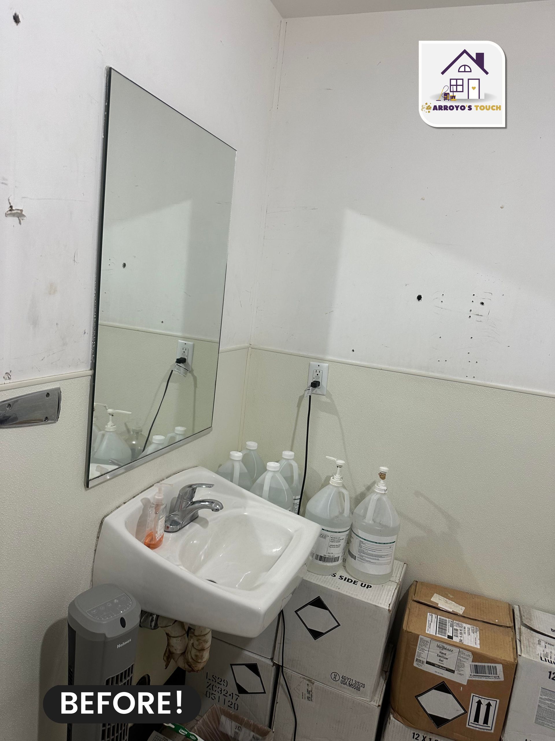 A small, messy bathroom with a mirror, sink, cleaning supplies, and cardboard boxes. 