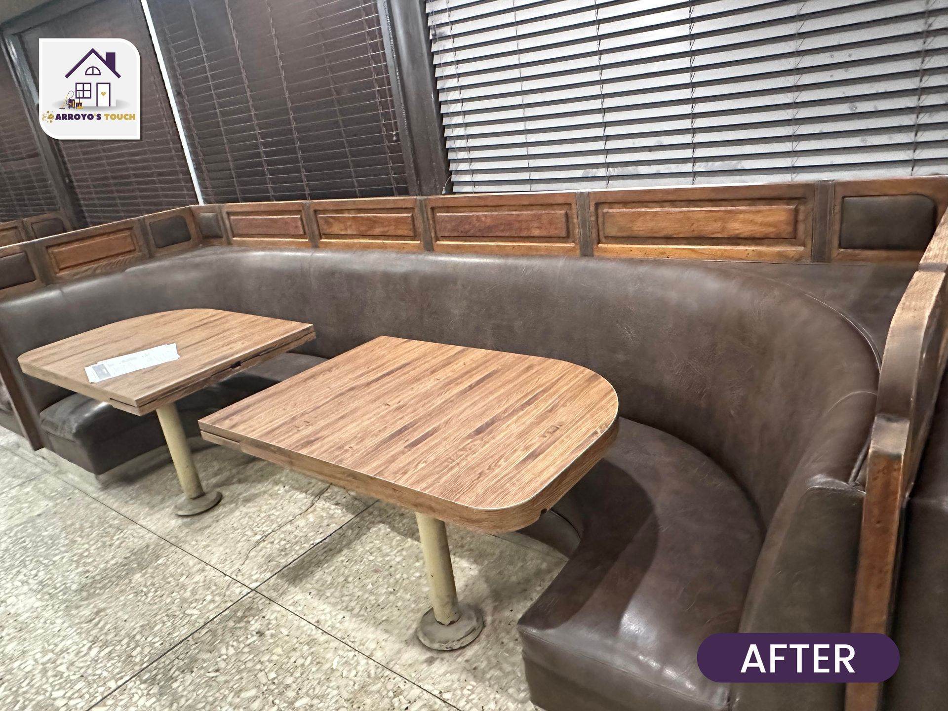Brown leather booth seating with wooden tables in a restaurant; after renovation.