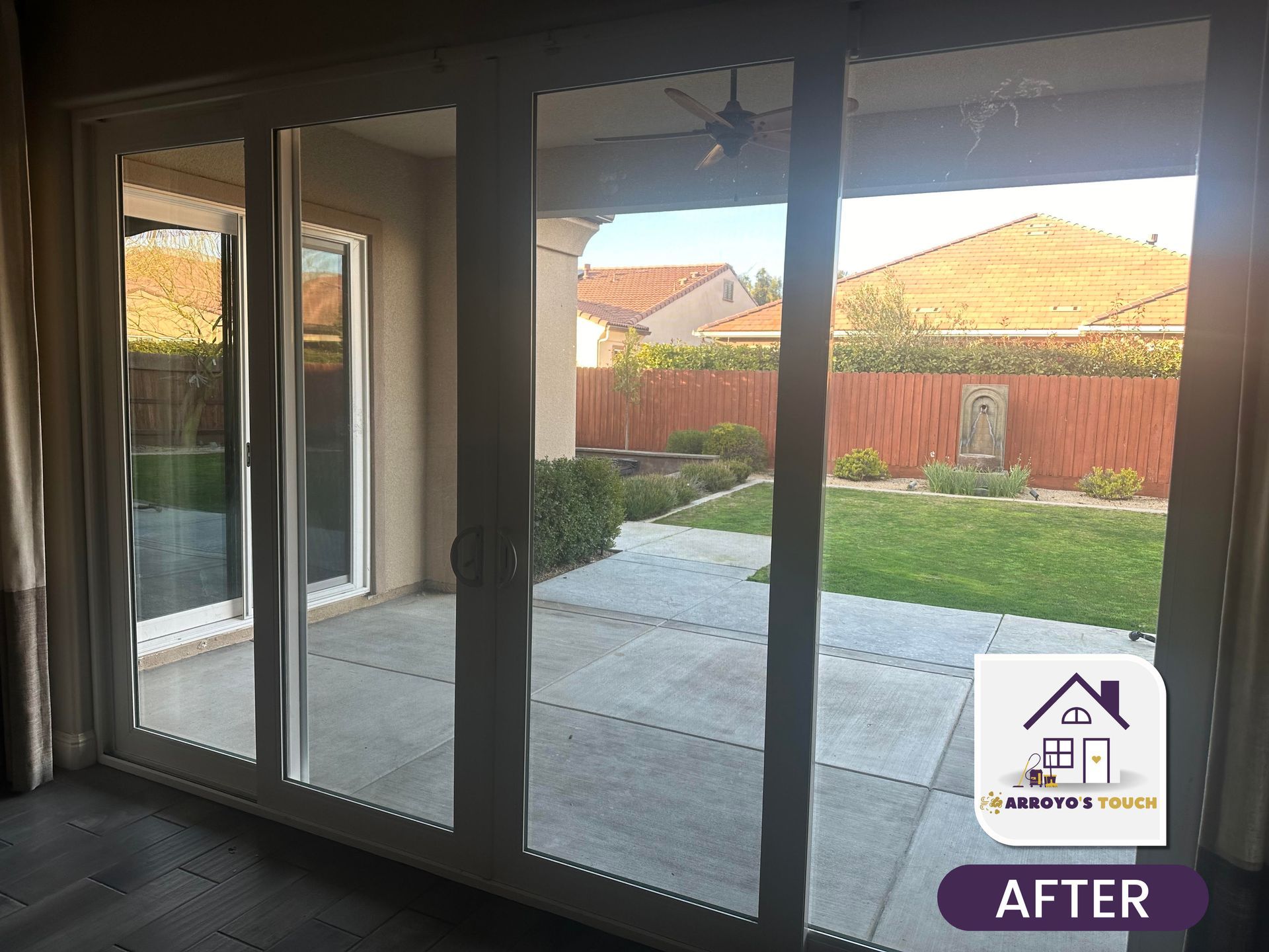 Sliding glass doors open to a backyard patio and lawn.