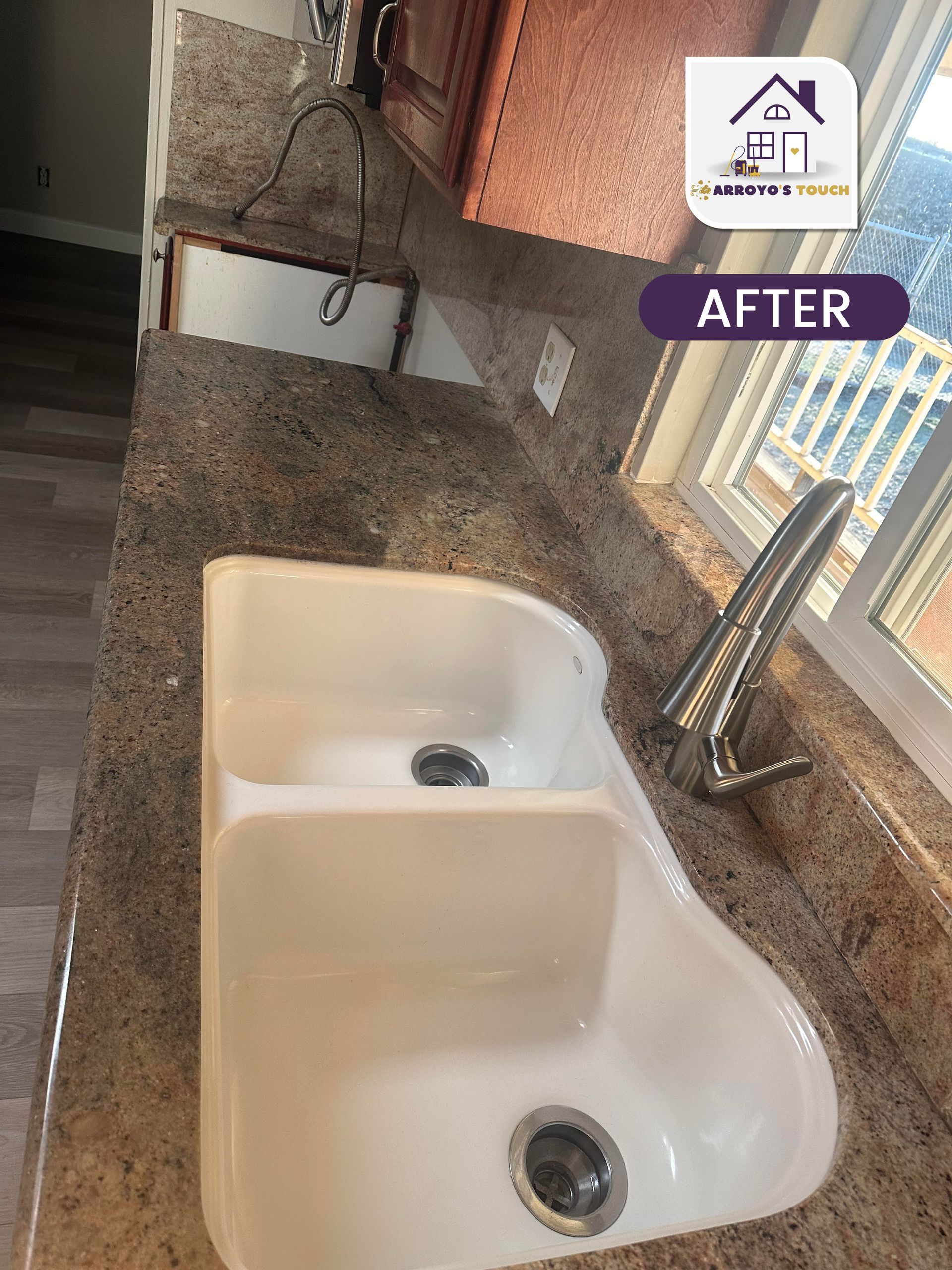 Kitchen sink with new granite countertop and faucet; after renovation.