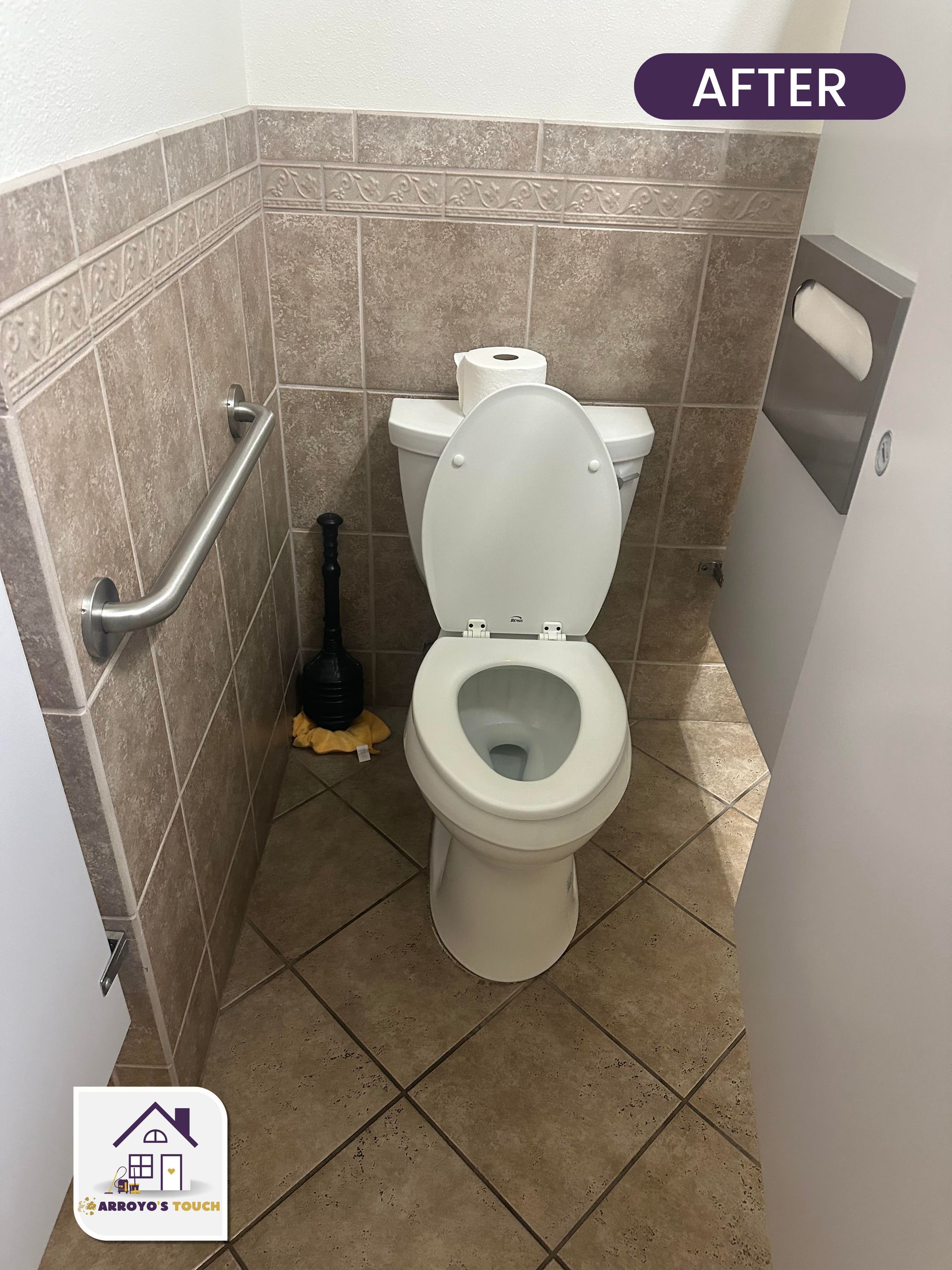 Toilet in a bathroom with grab bar, plunger, and tile. 
