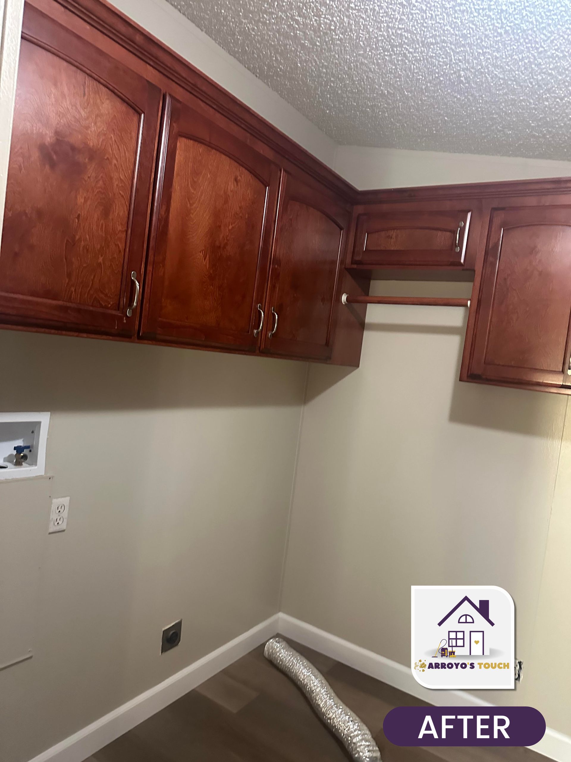 Laundry room with dark wood cabinets, beige walls, and a clothes rod.