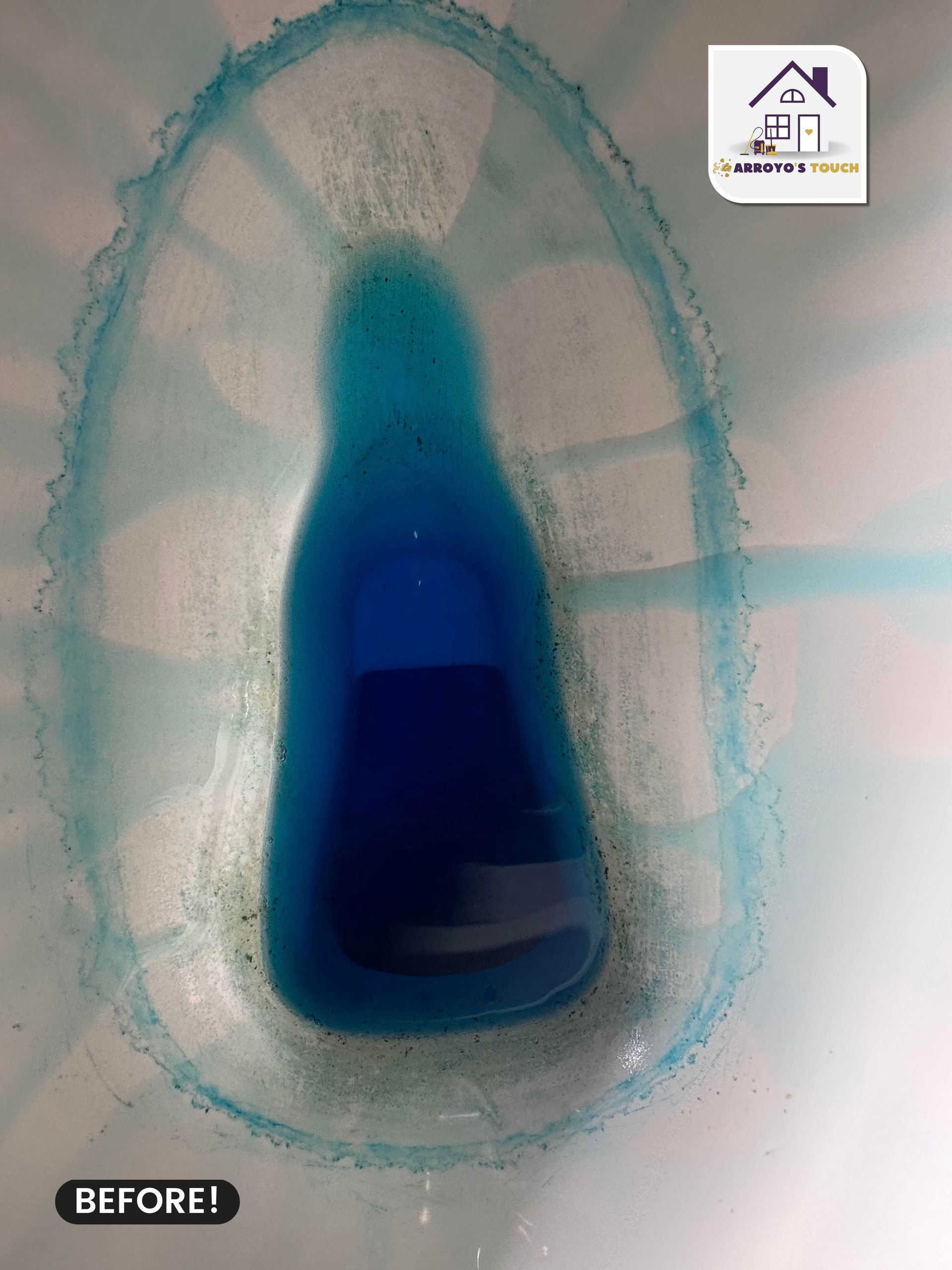 Toilet bowl with blue cleaner before cleaning; stained rim and water.