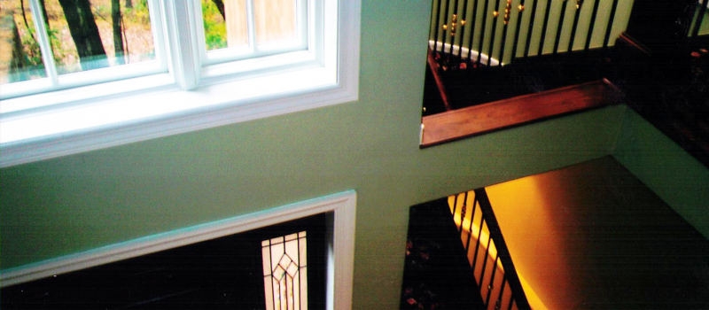 interior of home with vaulted ceilings painted green with white trim
