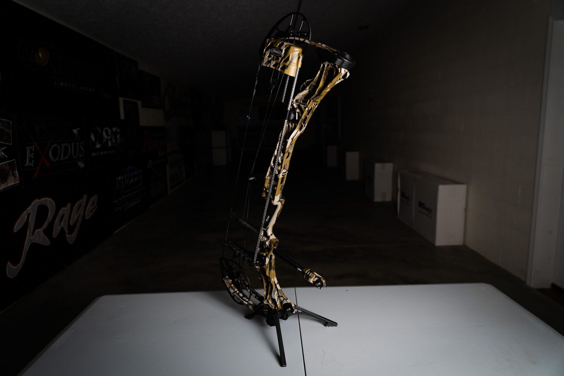 A saxophone is sitting on a white table in a dark room