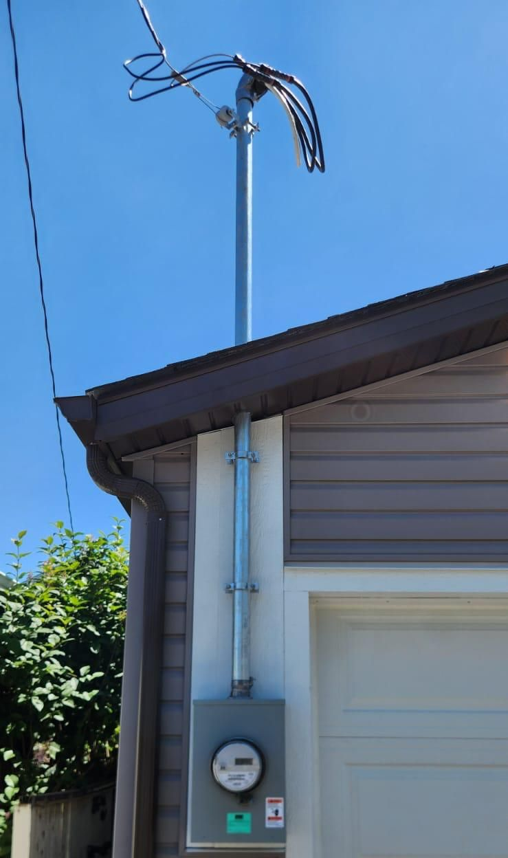 Overhead electrical service mast and meter upgrade on Edmonton garage