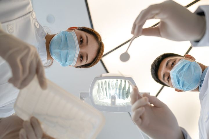 Back Shot Of Dentist Preparing For Surgery - Huntington, WV - Dr. Ben Brown The Denture Store
