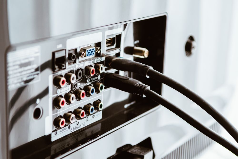 A Close Up Of The Back Of A Television With Cables Plugged Into It — Country to Coast Cabling in Yeppoon, QLD