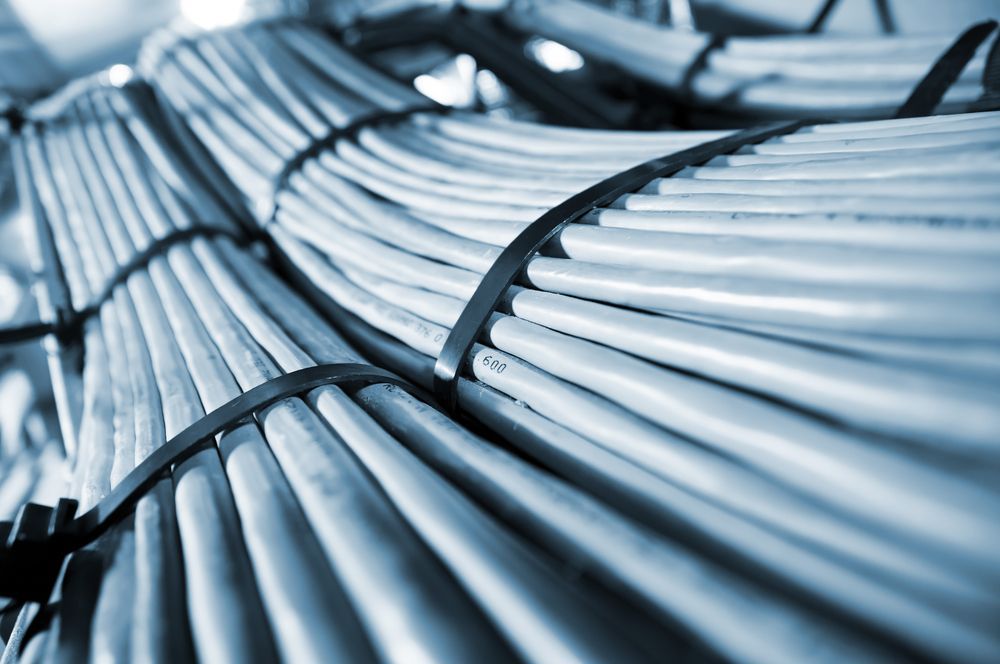 A Bunch Of Wires Are Stacked On Top Of Each Other In A Room — Country to Coast Cabling in Kawana, QLD