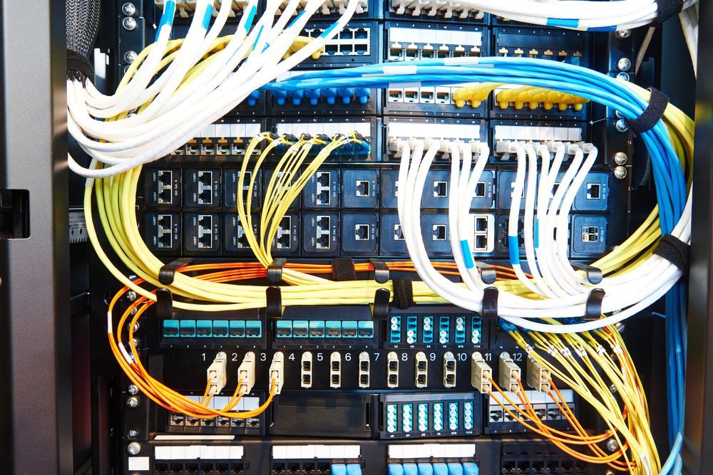 A Man Is Working On A Server In A Server Room — Country to Coast Cabling in Yeppoon, QLD