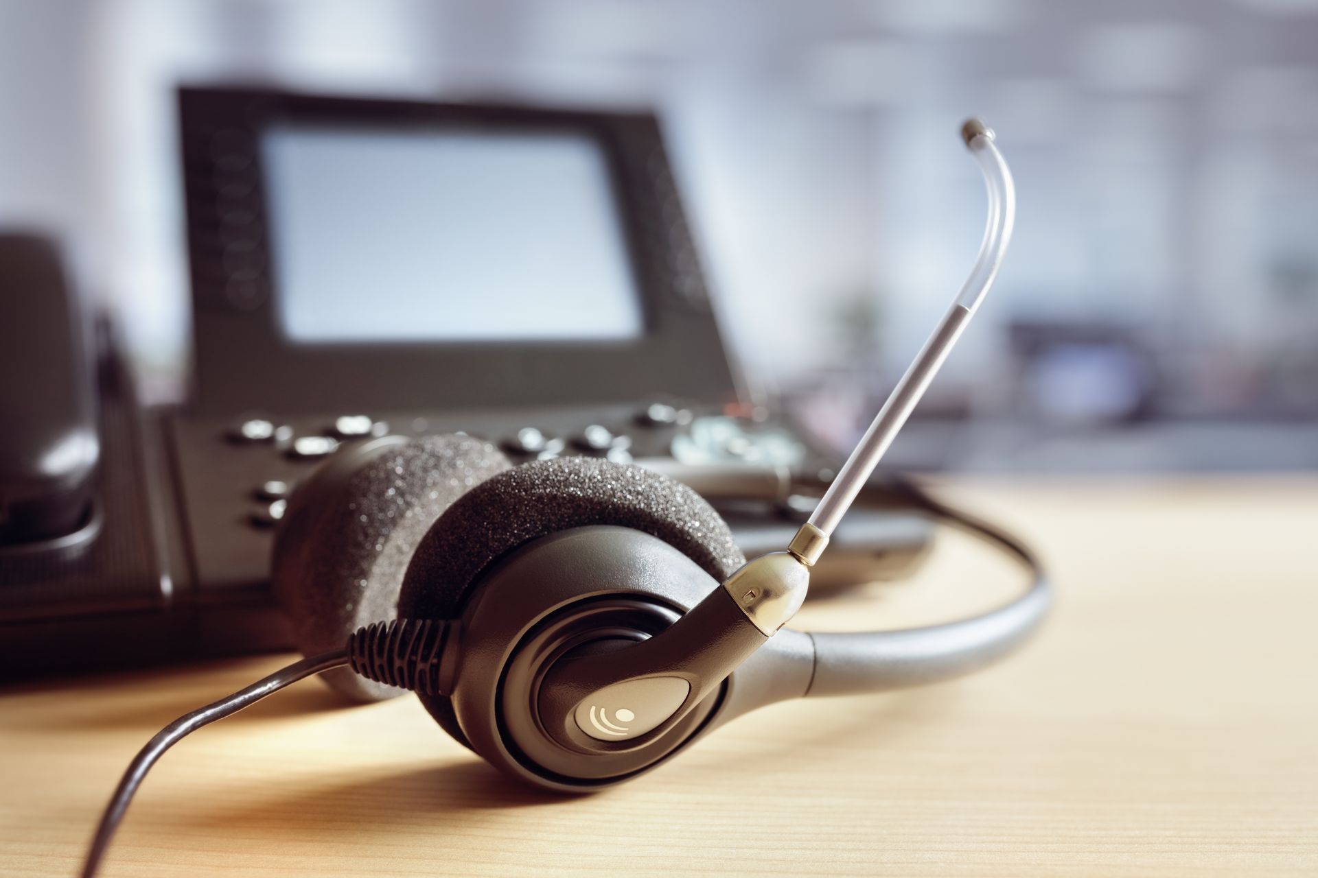 A Man Is Holding A Cell Phone In Front Of A Laptop And A Router — Country to Coast Cabling in Yeppoon, QLD