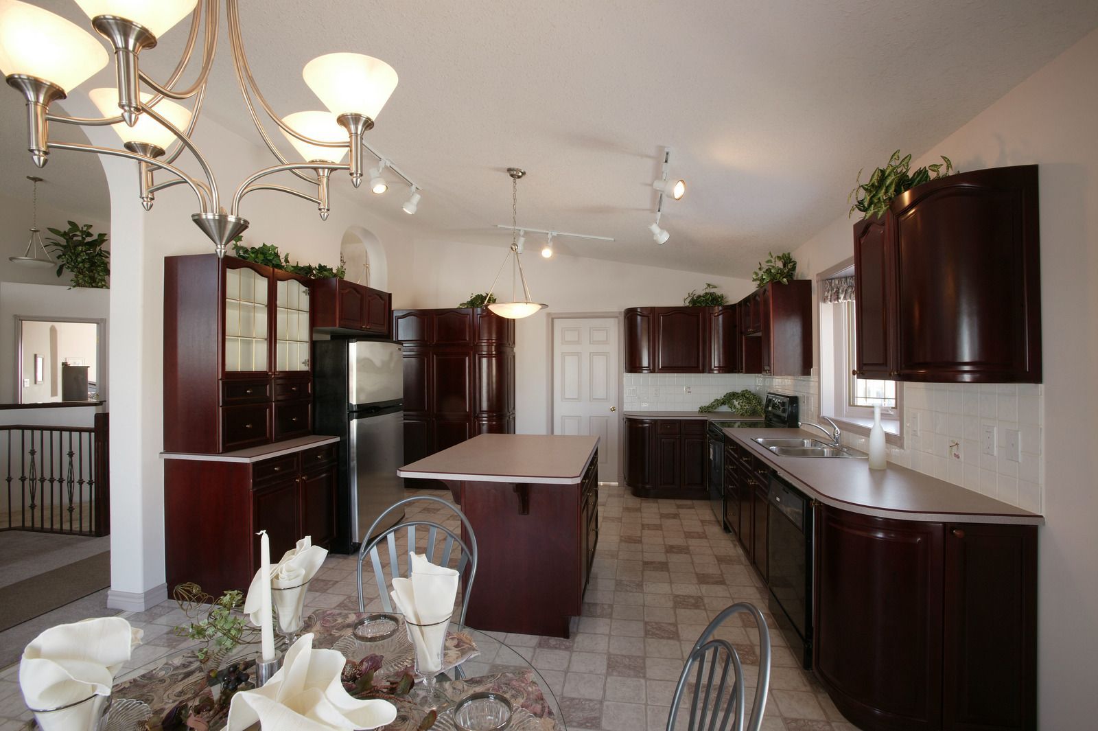 A kitchen with dark wood cabinets and stainless steel appliances