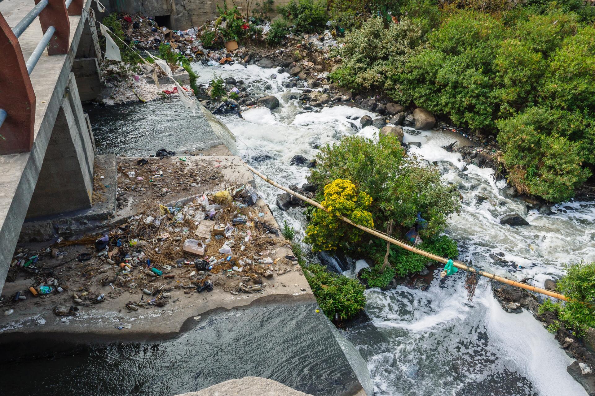 river with rubbish thrown in it