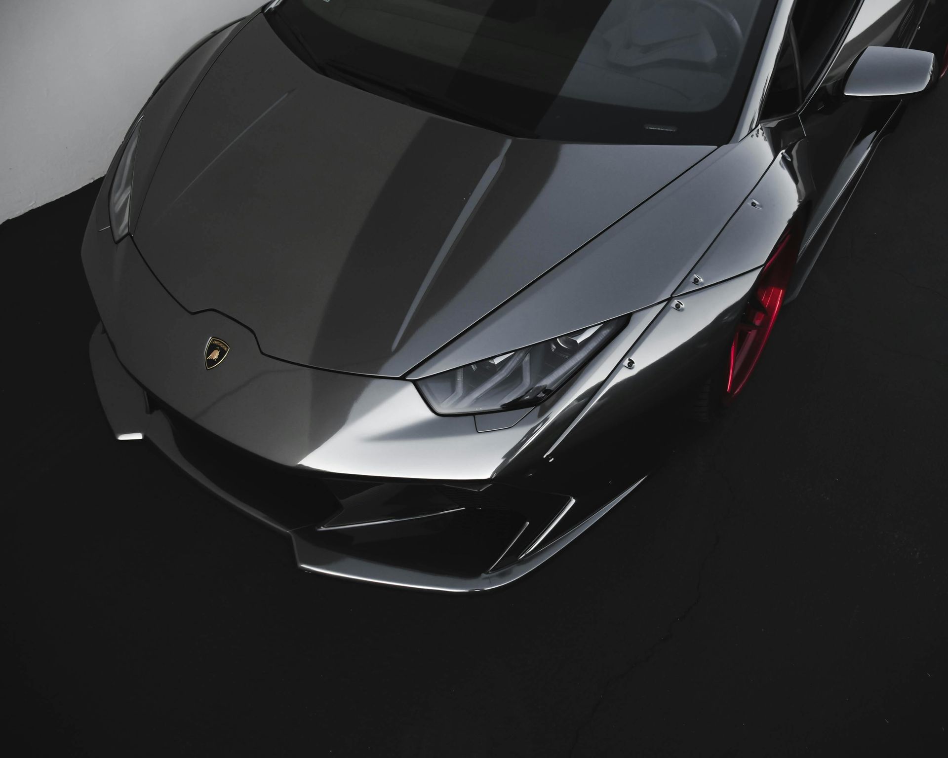 A close up of a black car with the word lamborghini on the front