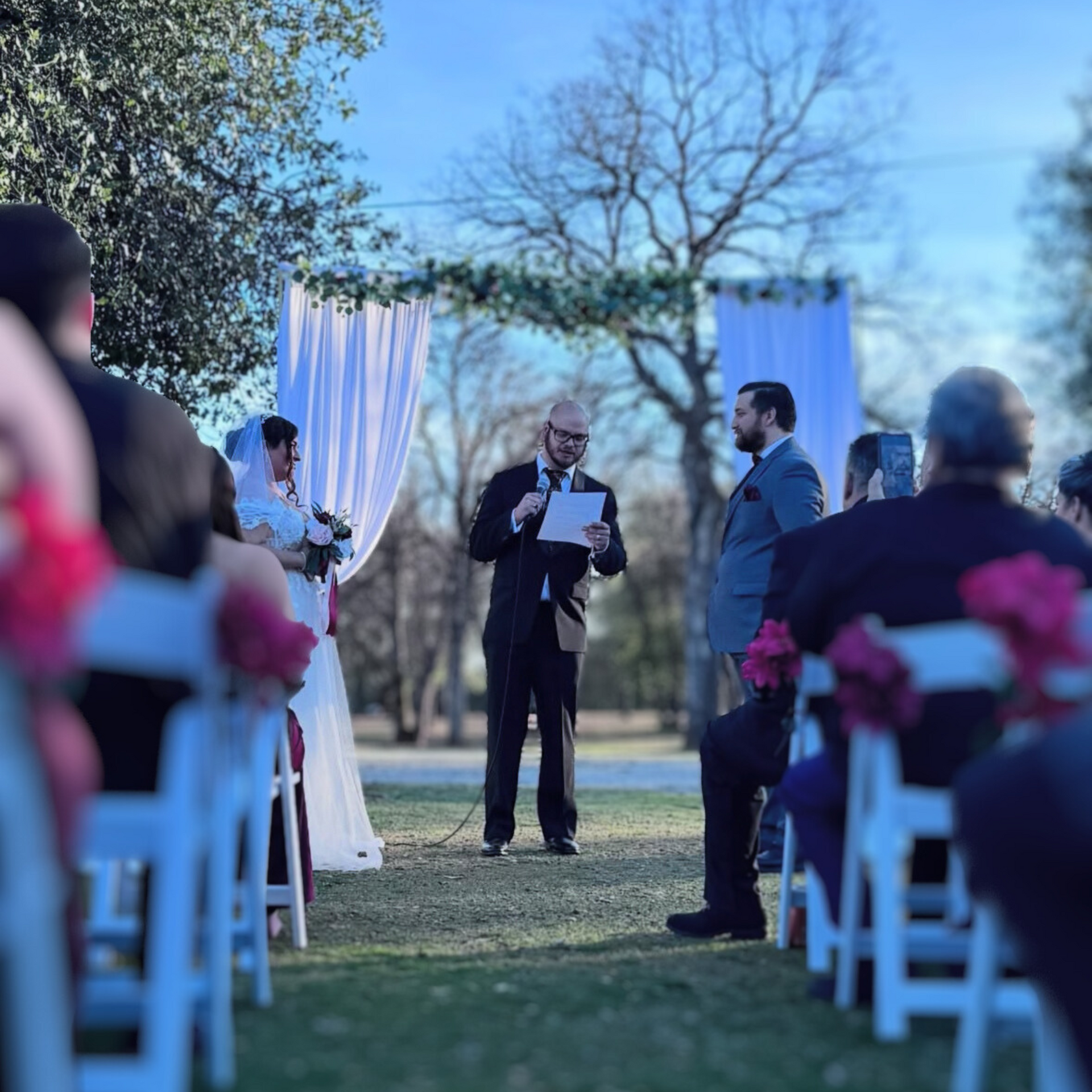 A man is giving a speech at a wedding ceremony.