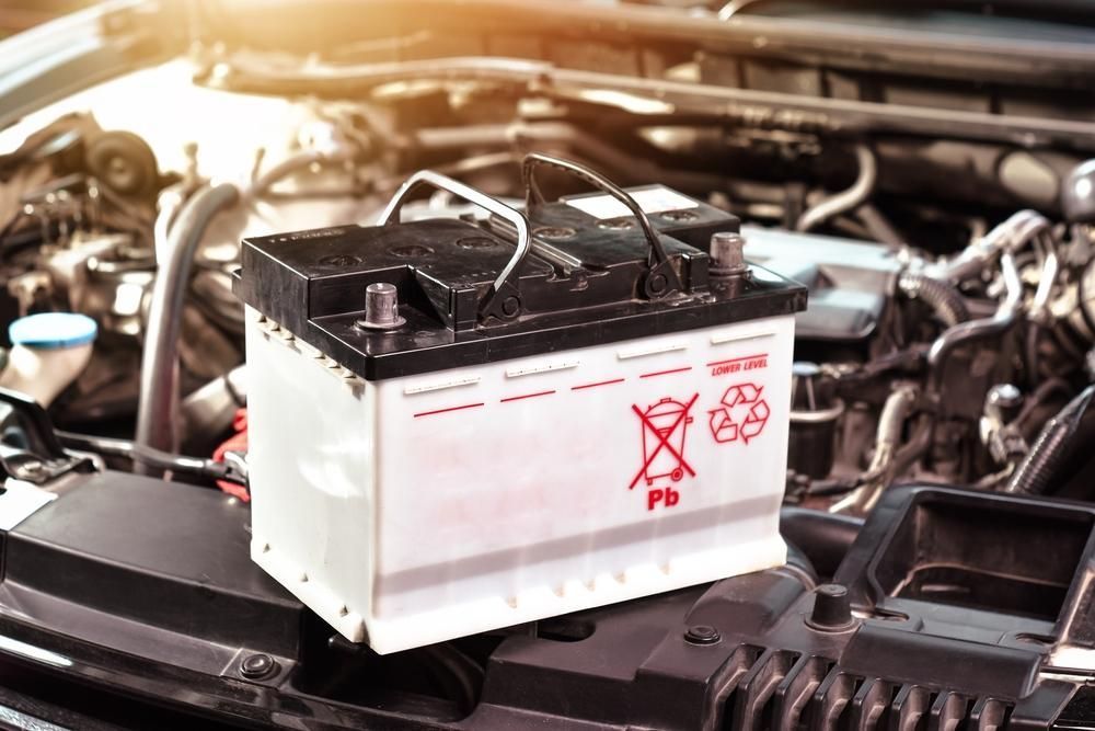 A Car Battery Is Sitting On The Hood Of A Car — SG Mobile Mechanic In Lake Macquarie, NSW