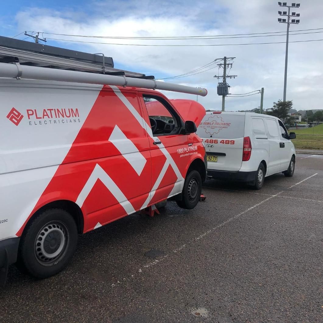 Two Platinum Vans Are Parked Next To Each Other — SG Mobile Mechanic In Newcastle, NSW